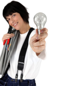 Female electrician showing light bulb
