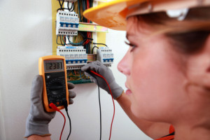 An electrician using a multimeter