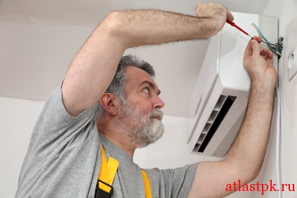 Electrical installation of air conditioner, electrician at work
